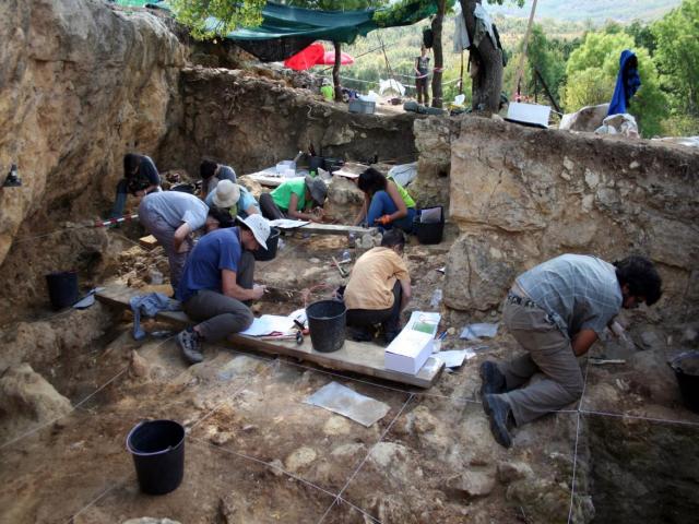 Grupo de arqueólogos excavando en el yacimiento de Abrigo del Navalmaíllo